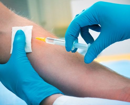 14304979 - doctor giving an injection to a patient