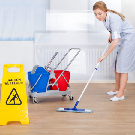 27242191 - portrait of young maid cleaning floor with mop