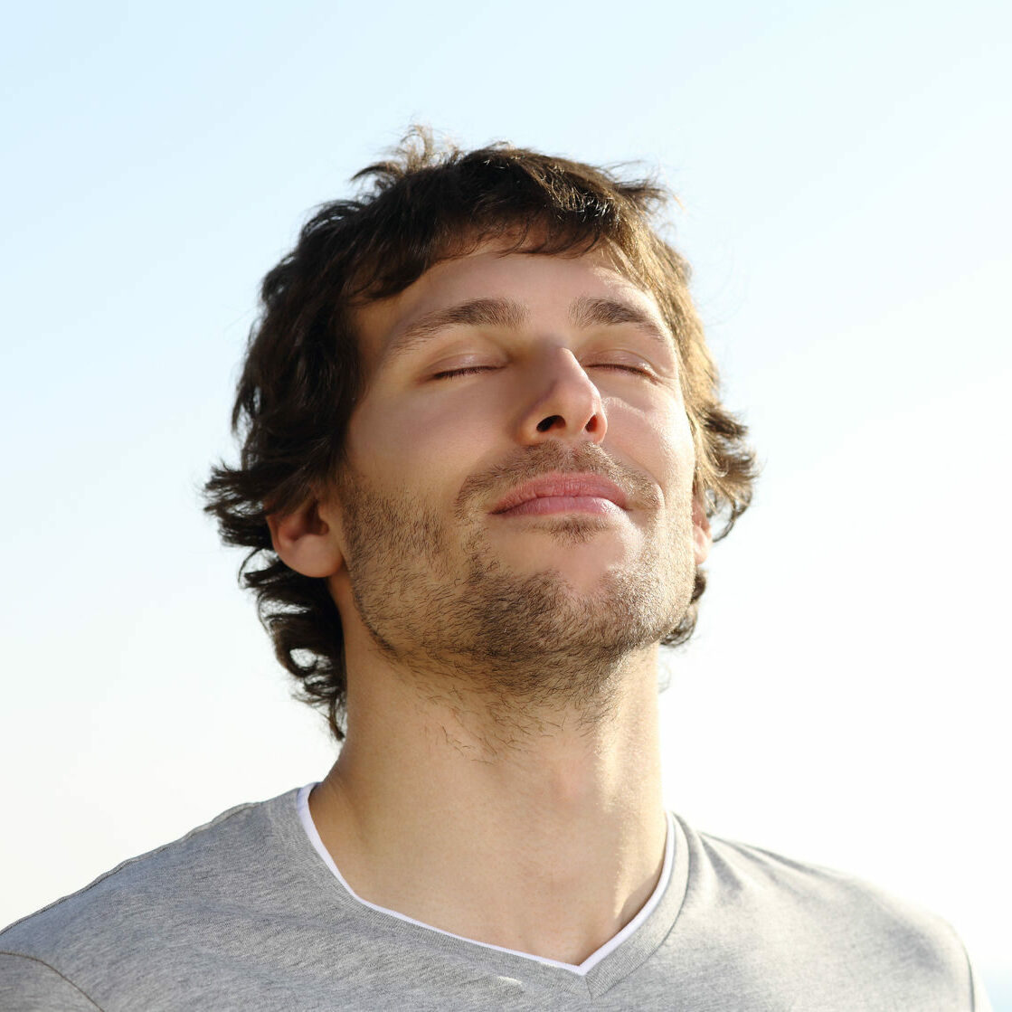 24327732 - attractive man breathing outdoor with the sky in the background