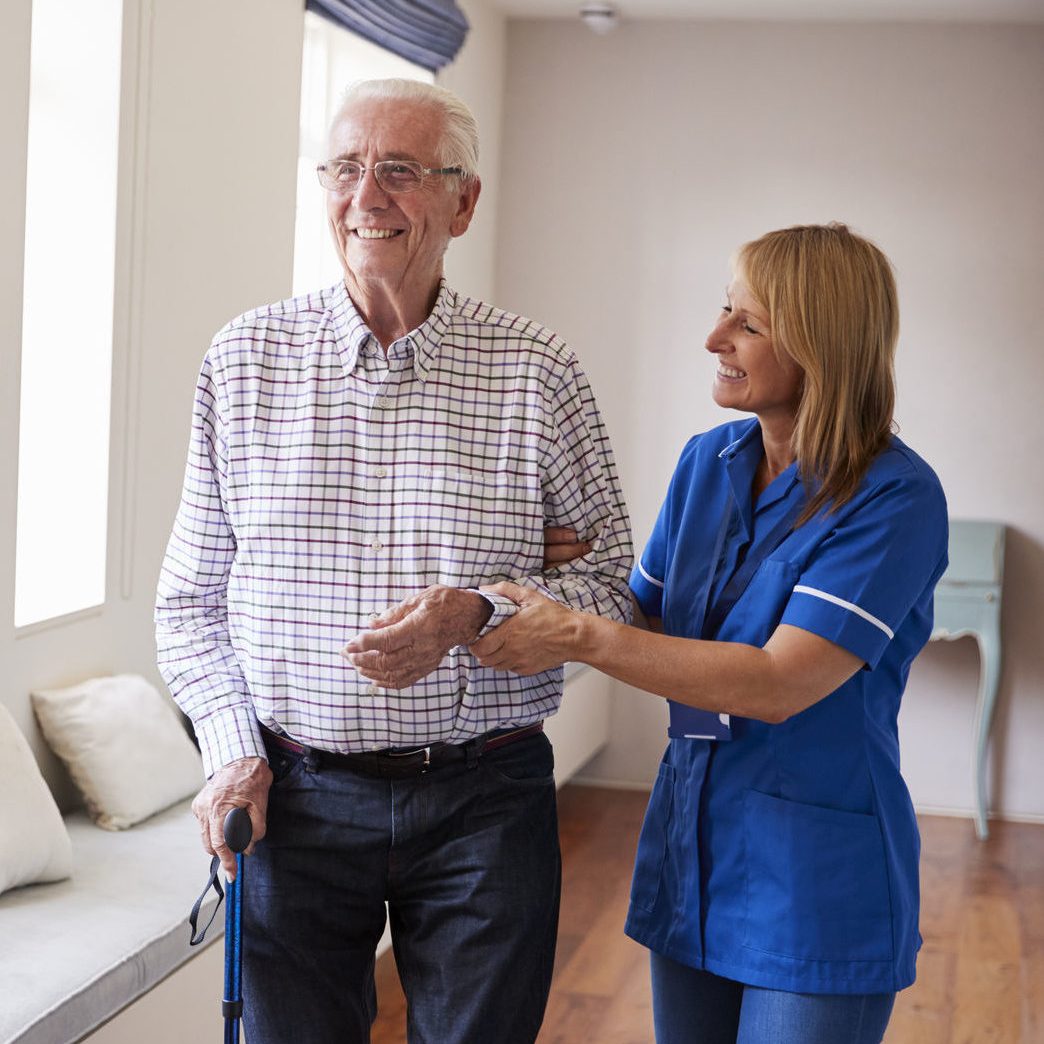 88062932 - nurse helping senior man walk using a walking stick